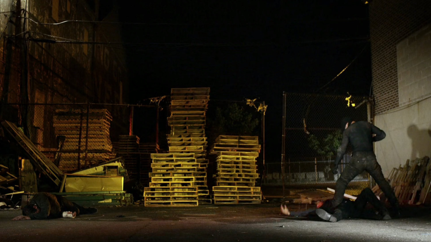 Daredevil and Vladimir fight in pallet yard outside Russian warehouse.