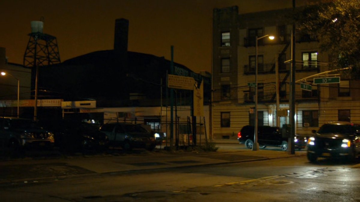 Night time shot Fisk motorcade turning corner at intersection of New York.