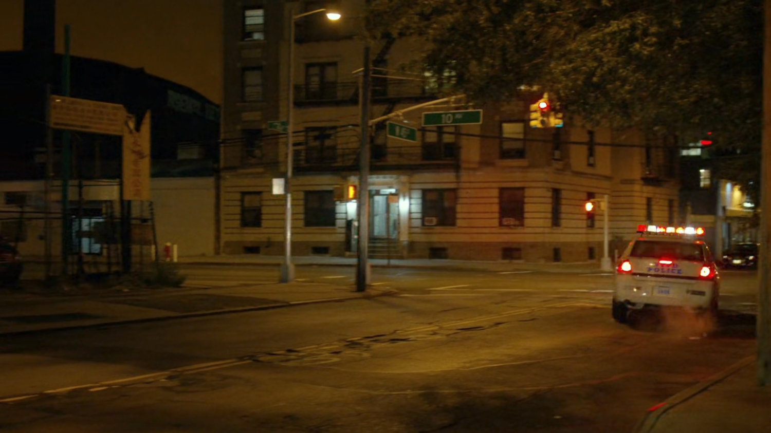Police car turning corner at intersection of New York.