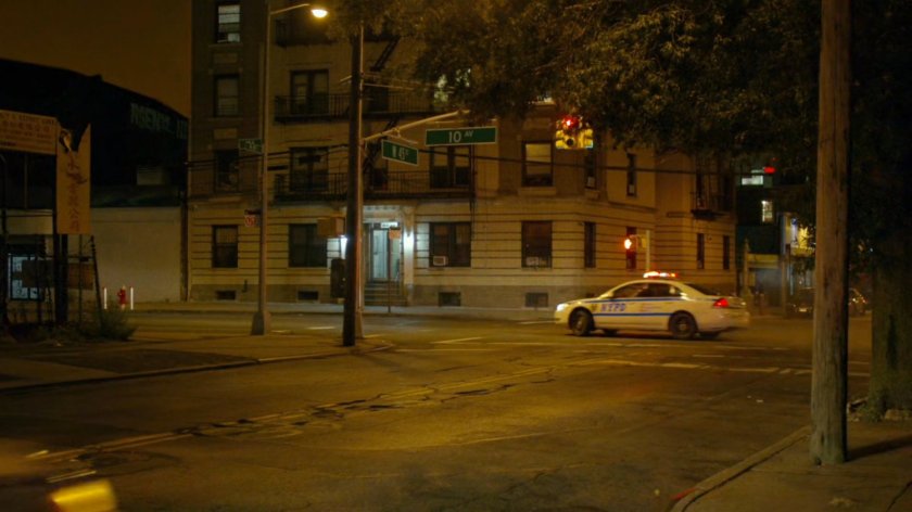 Police car turning corner at intersection of New York.
