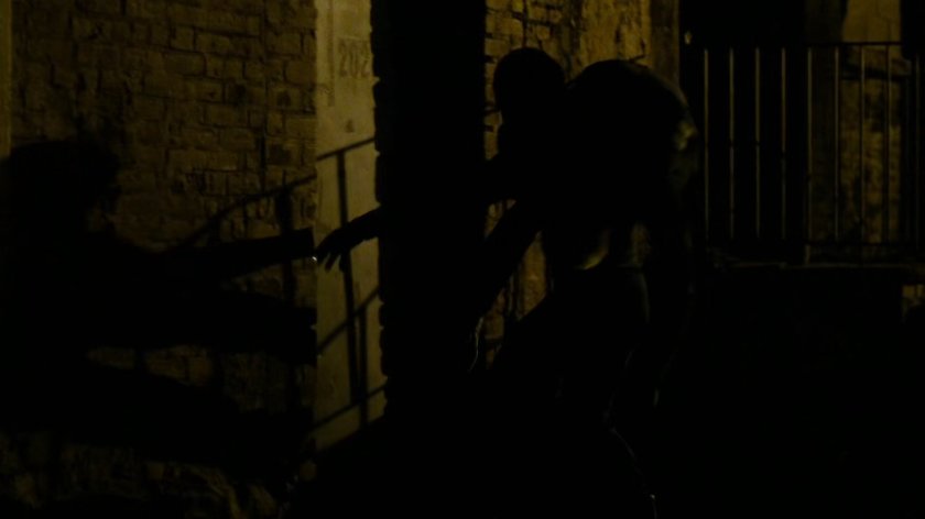 Daredevil carrying Vladimir on his shoulder entering abandoned warehouse labeled #202.