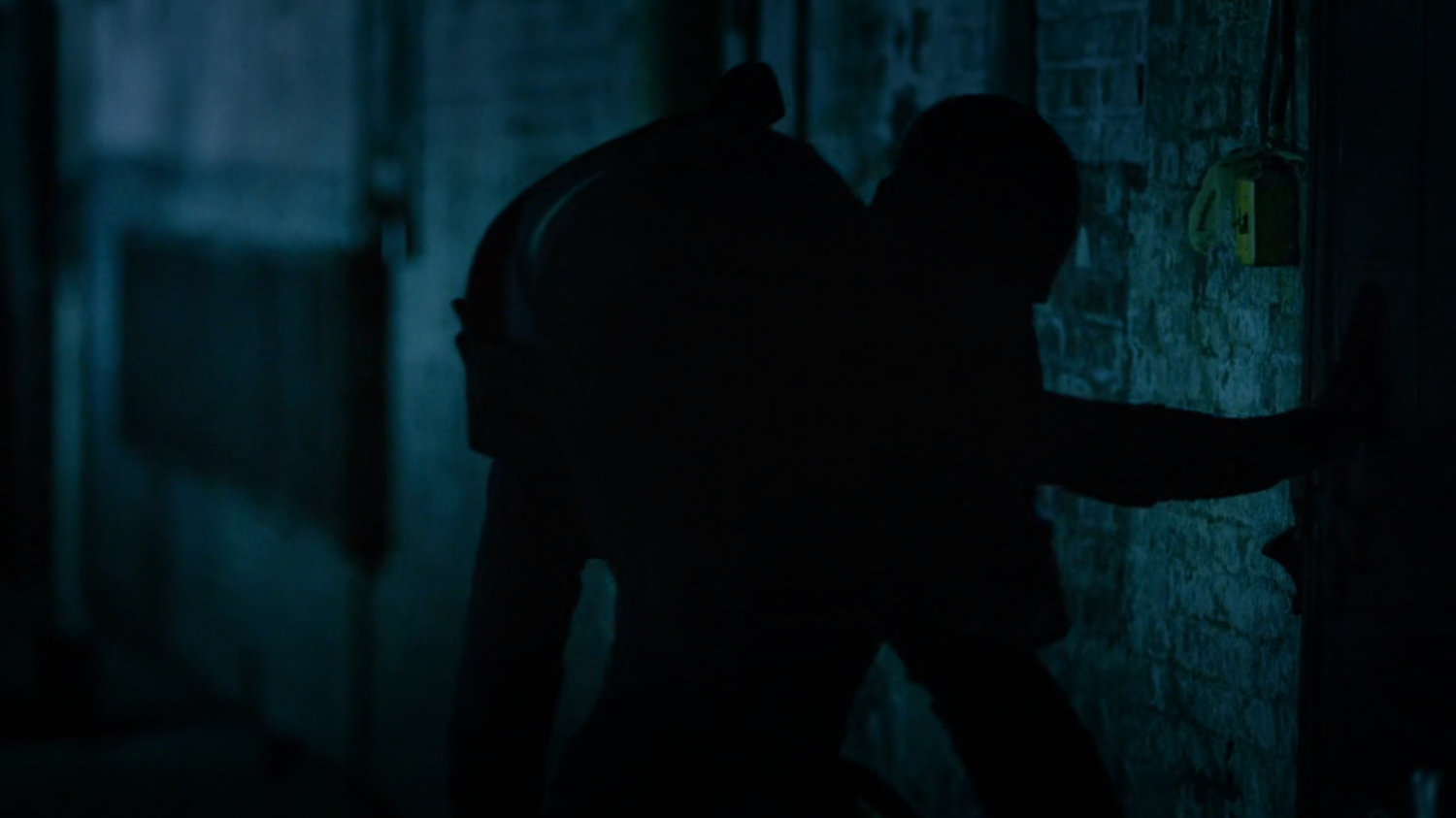 Daredevil carrying Vladimir on his shoulder inside abandoned warehouse.