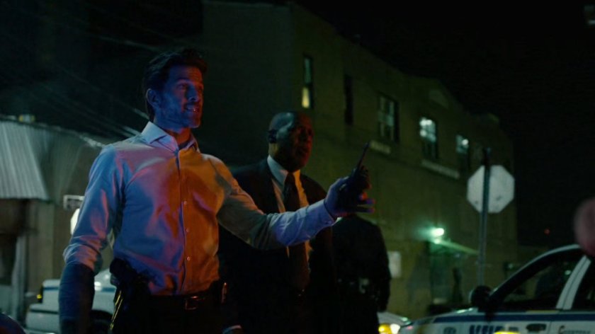 Police officers outside of abandoned warehouse.