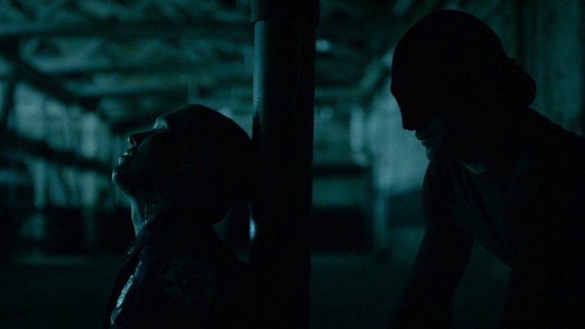 Daredevil restrains police officer inside abandoned warehouse.