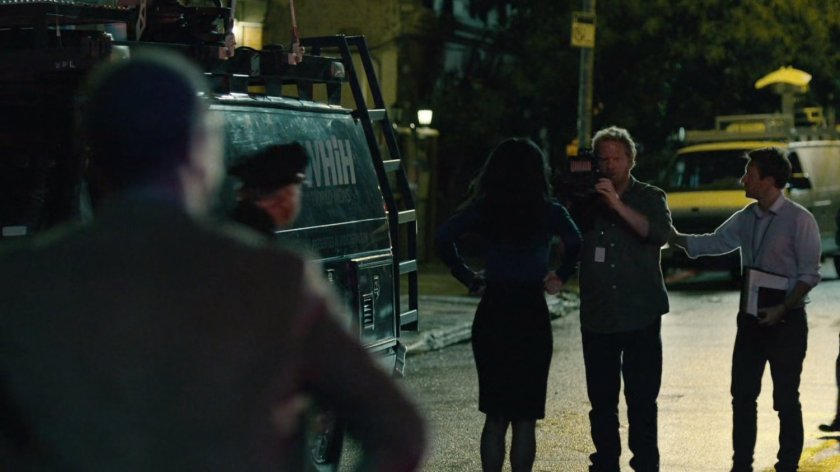 News crew outside of abandoned warehouse.