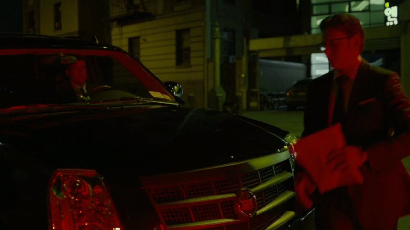 Wesley walks around front of Fisk motorcade.