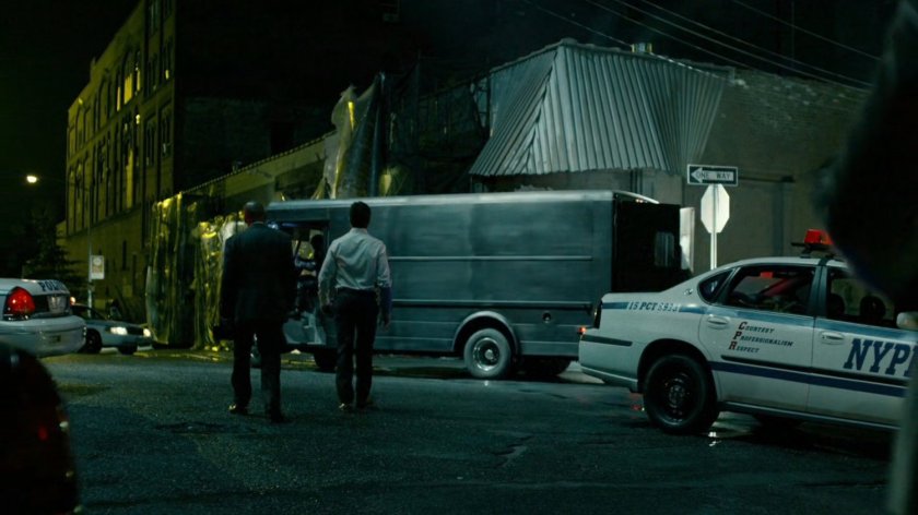 Police officers outside of abandoned warehouse.