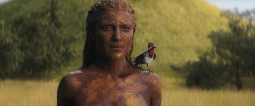 Chafa standing in front of mother mound with woodpecker on her shoulder.