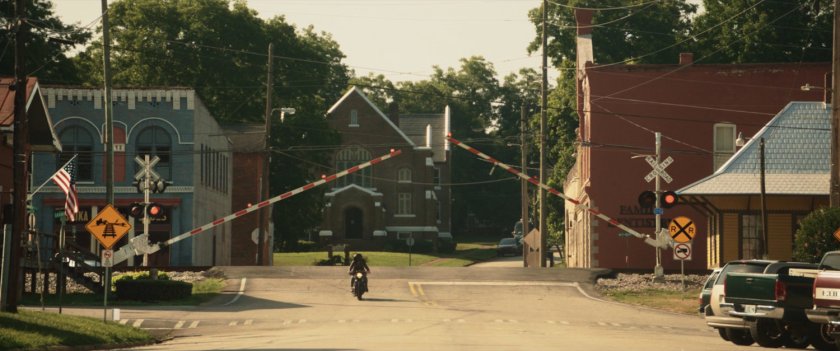 Maya on motorcycle driving through downtown Tamaha.