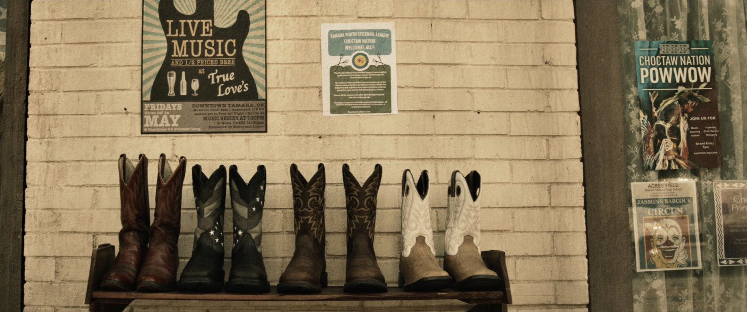 Exterior of building with cowboy boots and fliers.