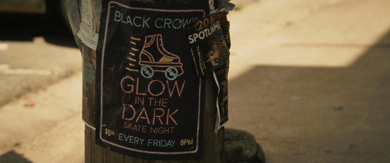 Pole with flyer for Glow in the Dark Skate Night.