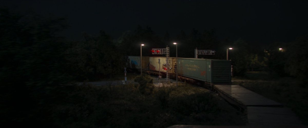 Train driving over road crossing.