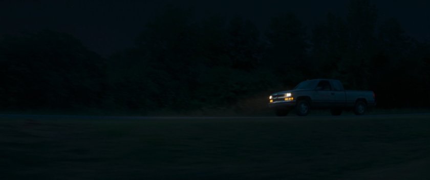 Pickup truck on highway at night.