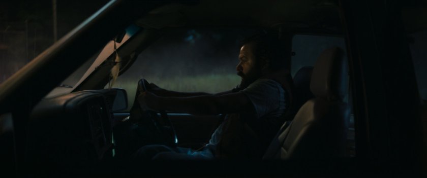 Biscuits stopping pickup in field at night.