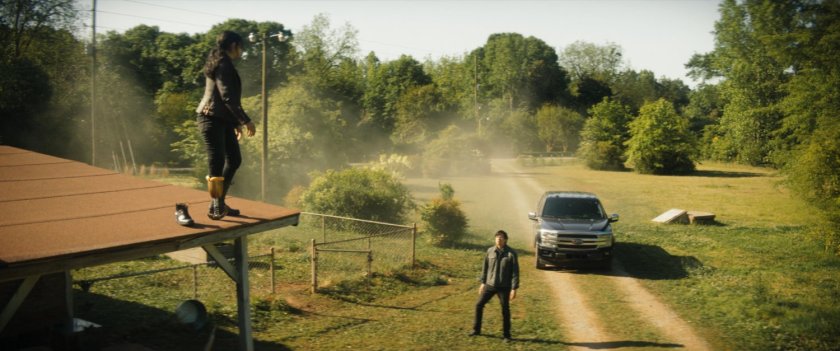 Maya on roof of Lopez house speaking with Henry below.