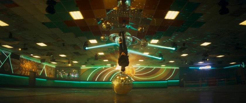 Maya hanging upside down inside of Black Crow's SkateLife Roller Skating.