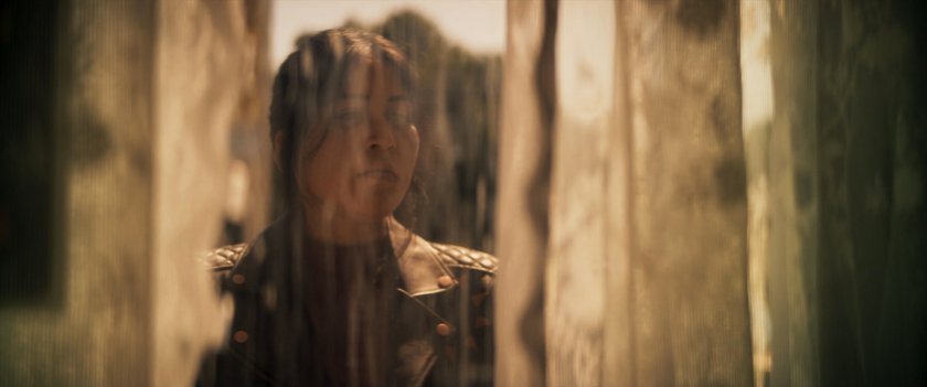Maya looking into window of Tamaha Bar.