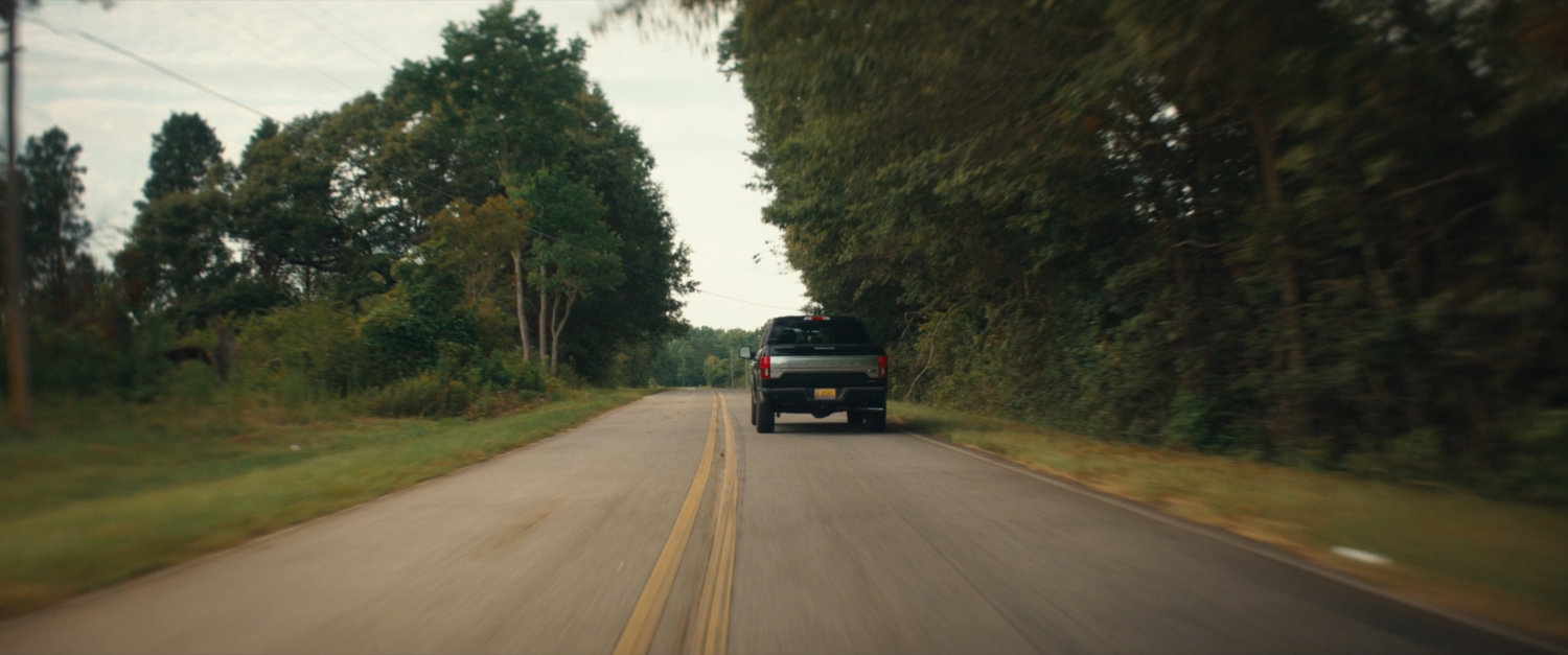 Pickup truck on country road.