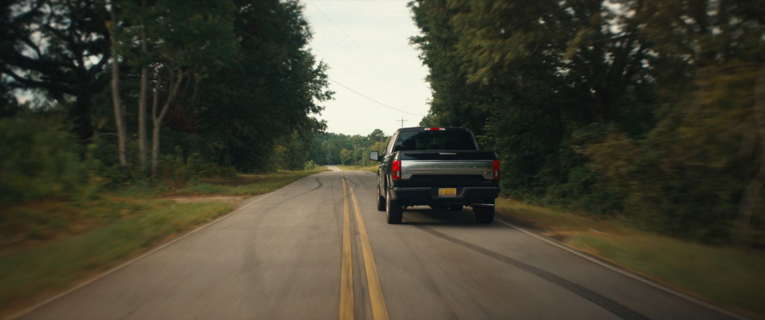 Pickup truck on country road.