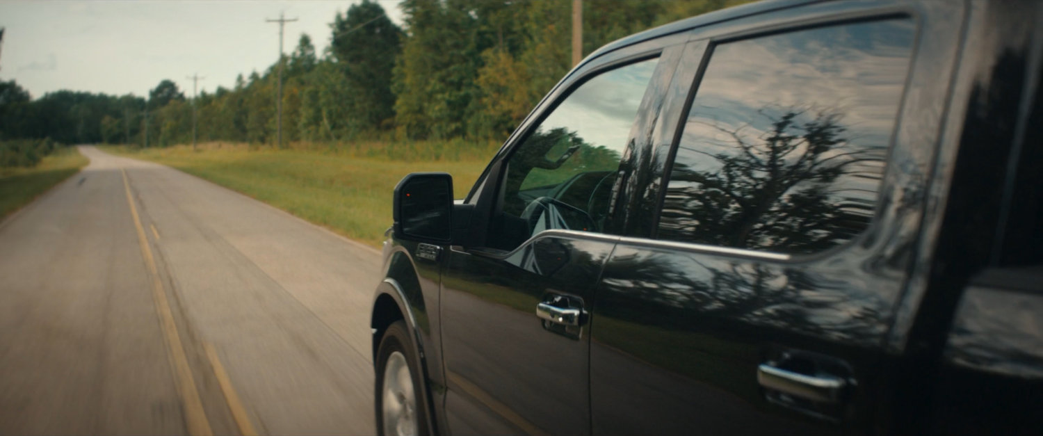 Pickup truck on country road.