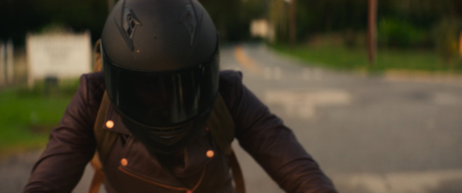 Closeup of Maya on her motorcycle in downtown Tamaha.