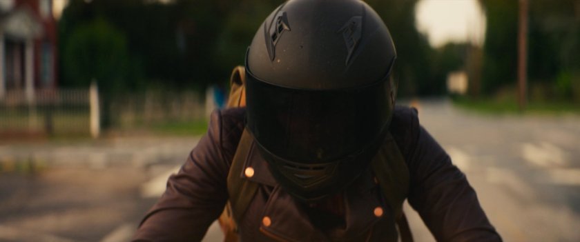 Closeup of Maya on her motorcycle in downtown Tamaha.
