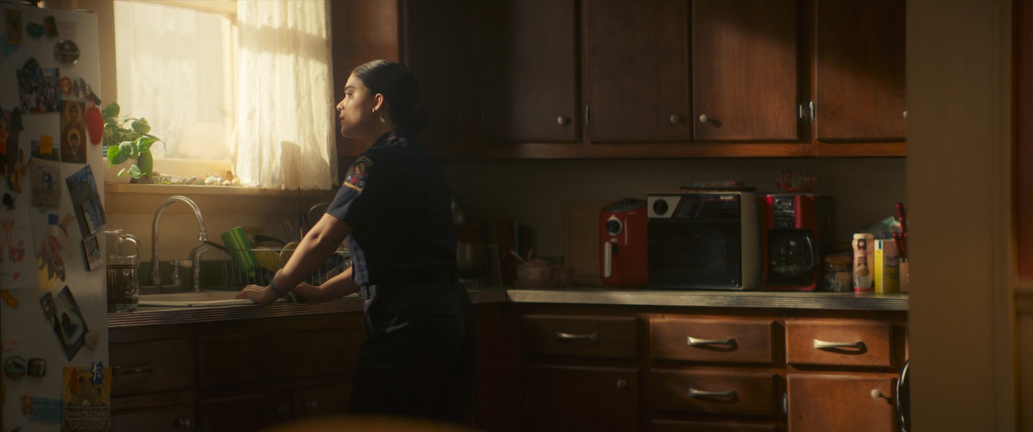 Bonnie standing in her kitchen.