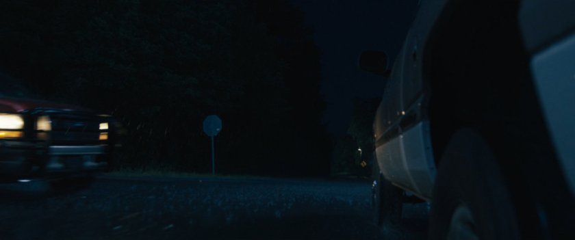 A rainy road and intersection at night where Maya and her mother have an accident.