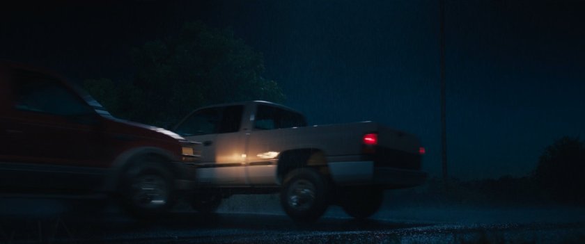 A rainy road and intersection at night where Maya and her mother have an accident.