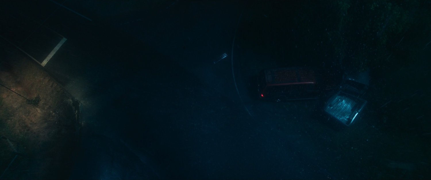 A rainy road and intersection at night where Maya and her mother have an accident.