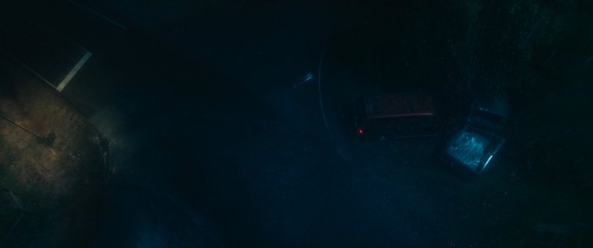 A rainy road and intersection at night where Maya and her mother have an accident.