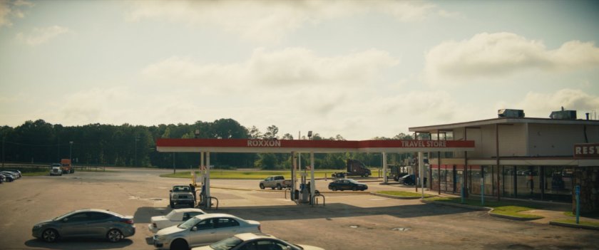 Maya pulling her motorcycle in to Roxxon Travel Store.