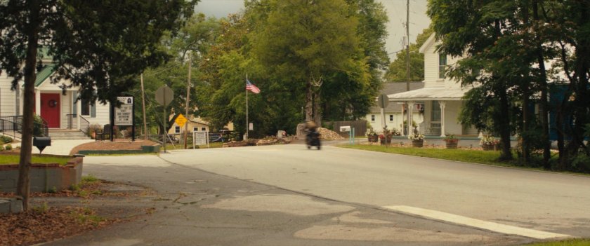 Maya on motorcycle driving out of downtown Tamaha.