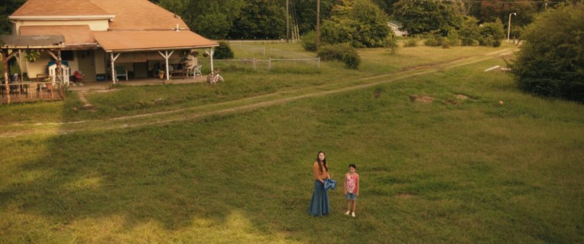 Young Maya and Taloa release a woodpecker out back of the Lopez House.