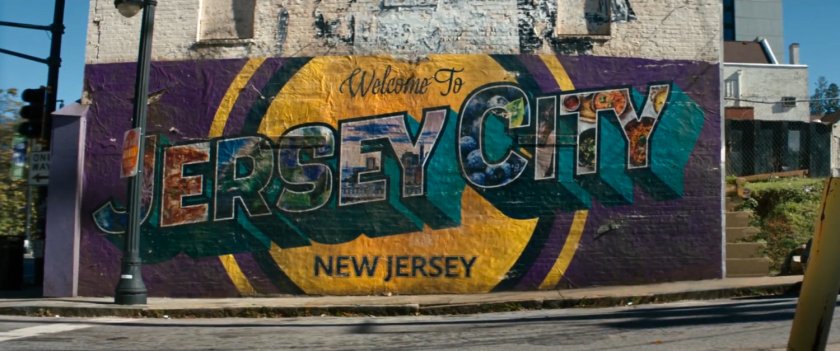 Street corner building with mural. Text: Welcome to Jersey City, New Jersey.
