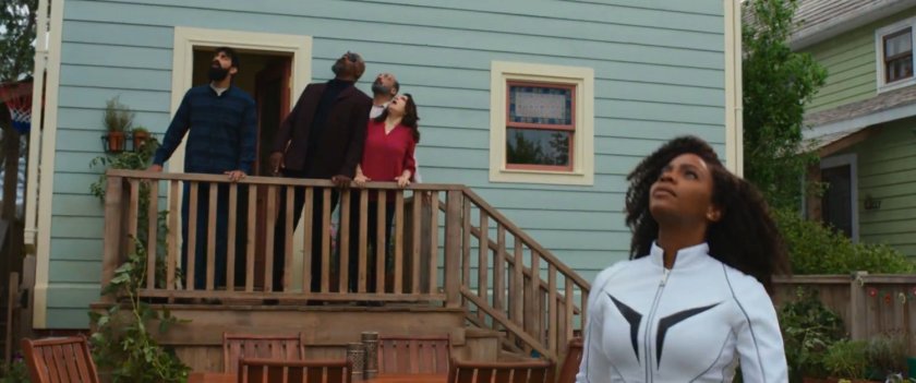 Monica and others look to the sky in the Khan backyard.