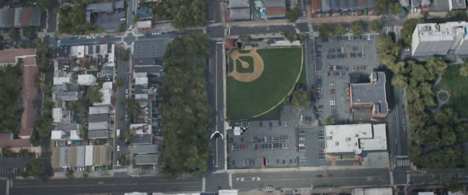 Monica flying above Jersey City baseball field.