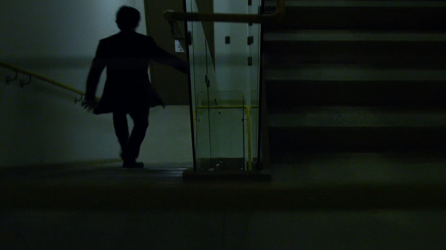 Aito runs down stairwell in Tokyo office building.