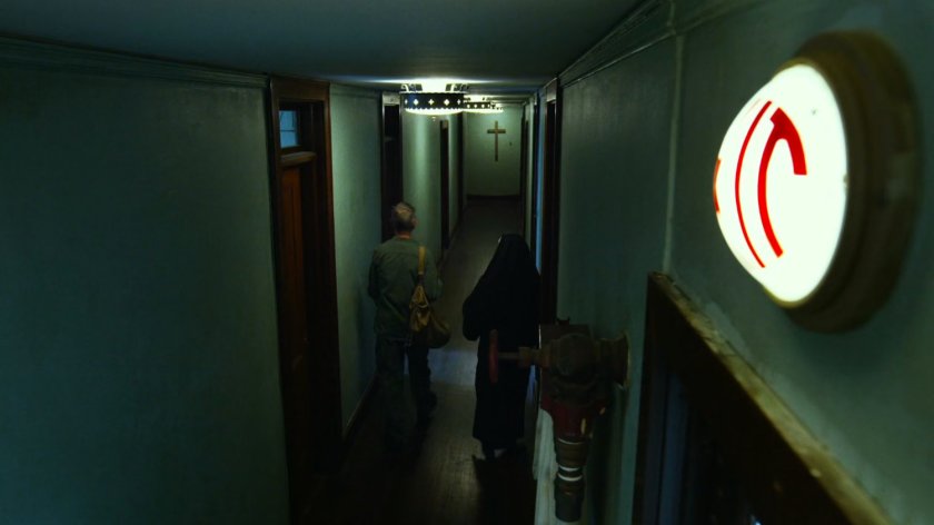 A nun escorts Stick down an orphanage hall.