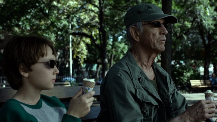 Stick and young Matt eating ice cream in a city park.