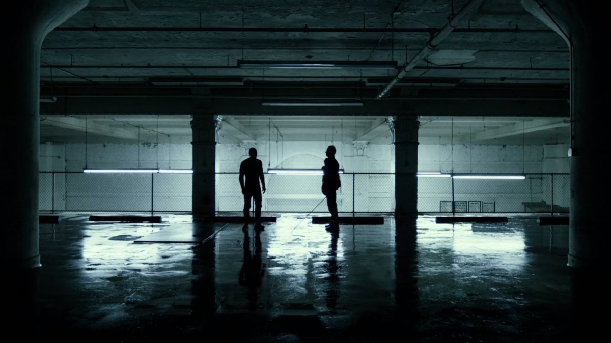 Stick and Matt in a stark, white parking garage.