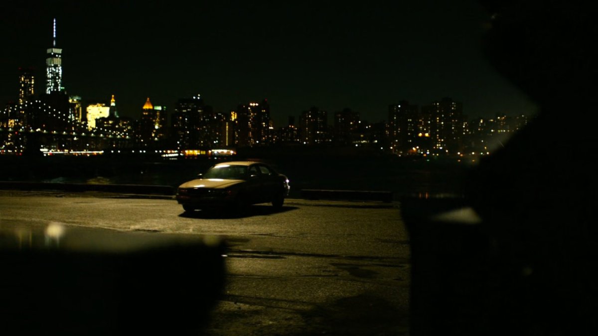 Ben's car parked on a deserted dock at night.