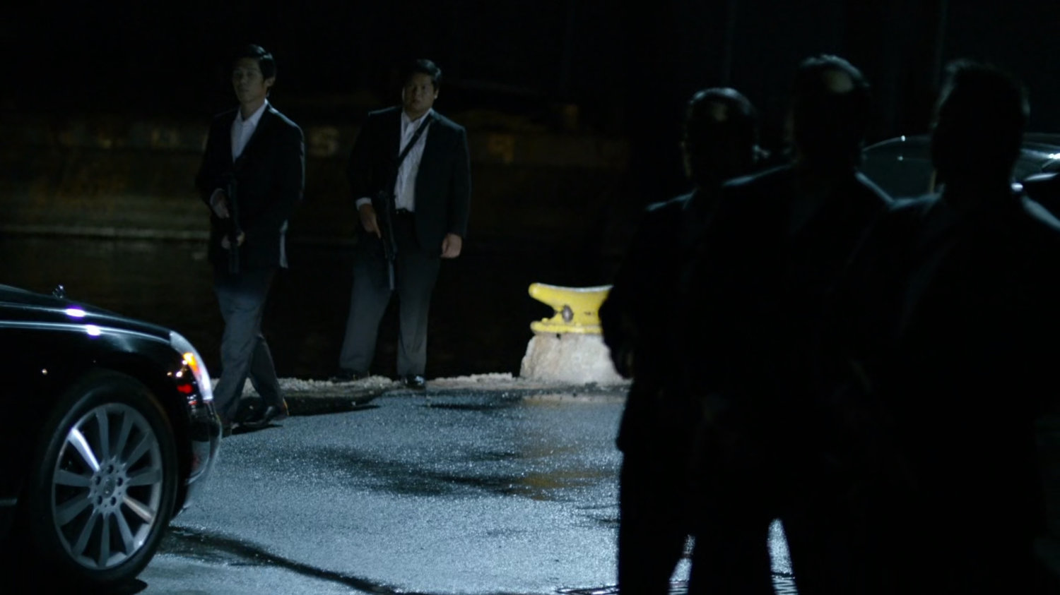 Members of Yakuza standing at docks where Black Sky is being delivered.