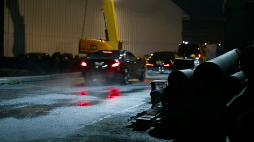 Cars drive away from docks where Black Sky is being delivered.