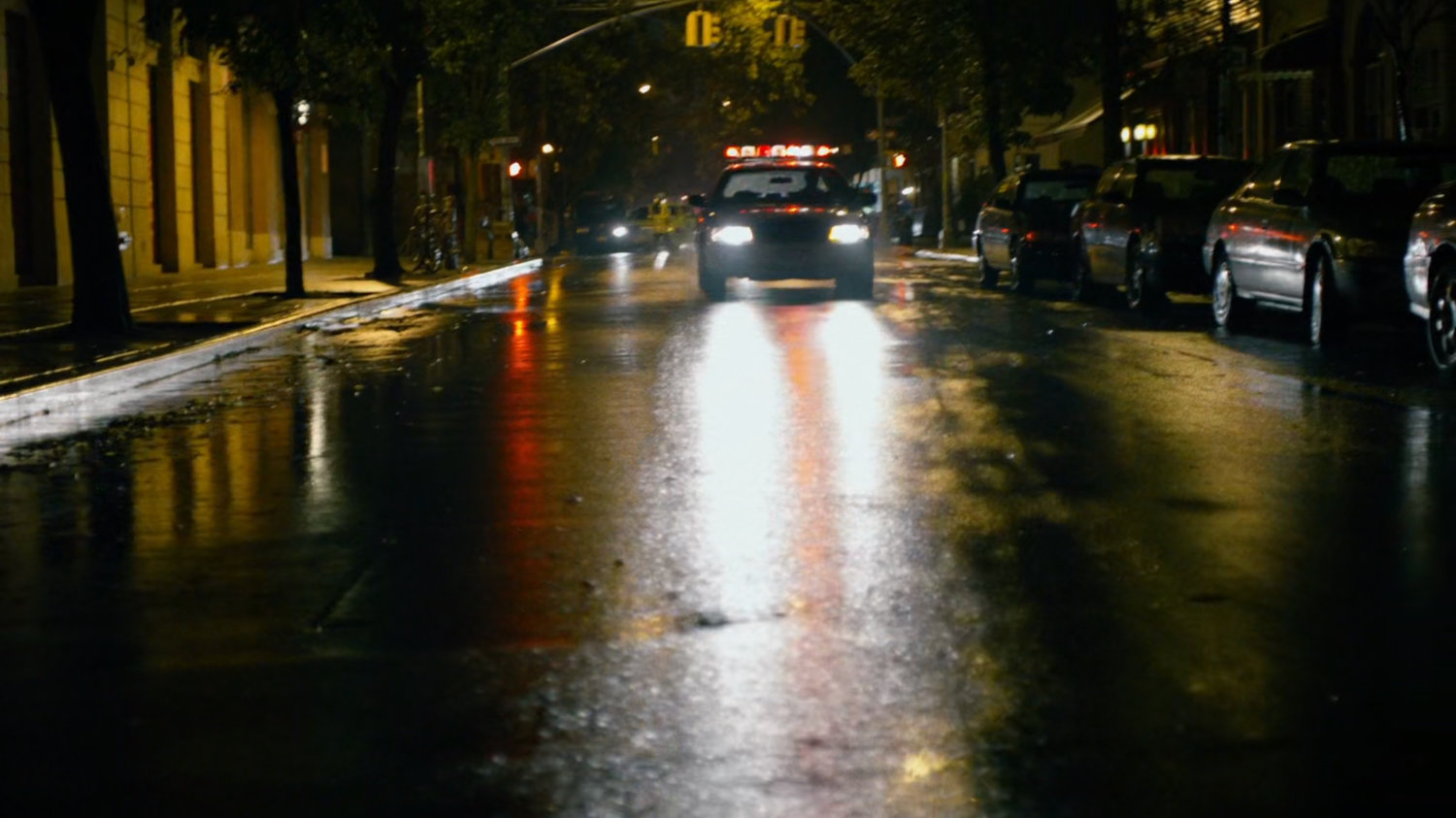 Police car on wet New York street.
