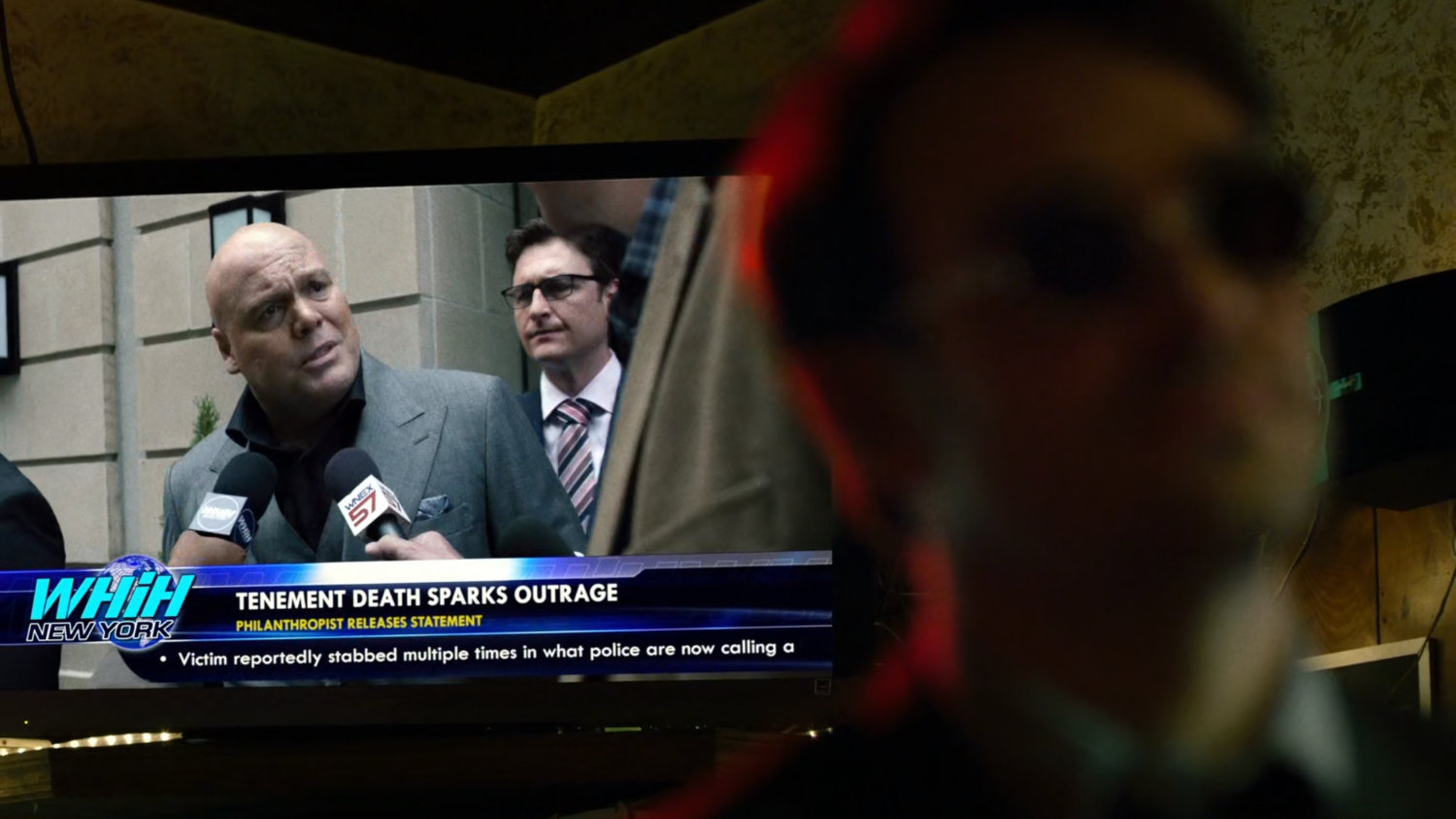 Fisk on television news report behind Matt in Josie's Bar.