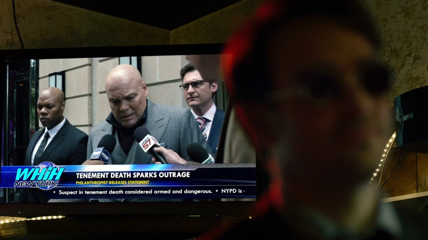 Fisk on television news report behind Matt in Josie's Bar.
