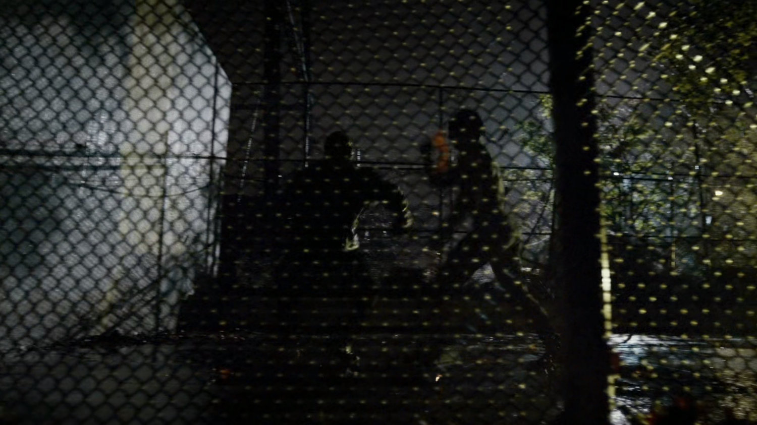 Daredevil beats up pusher in dark playground.