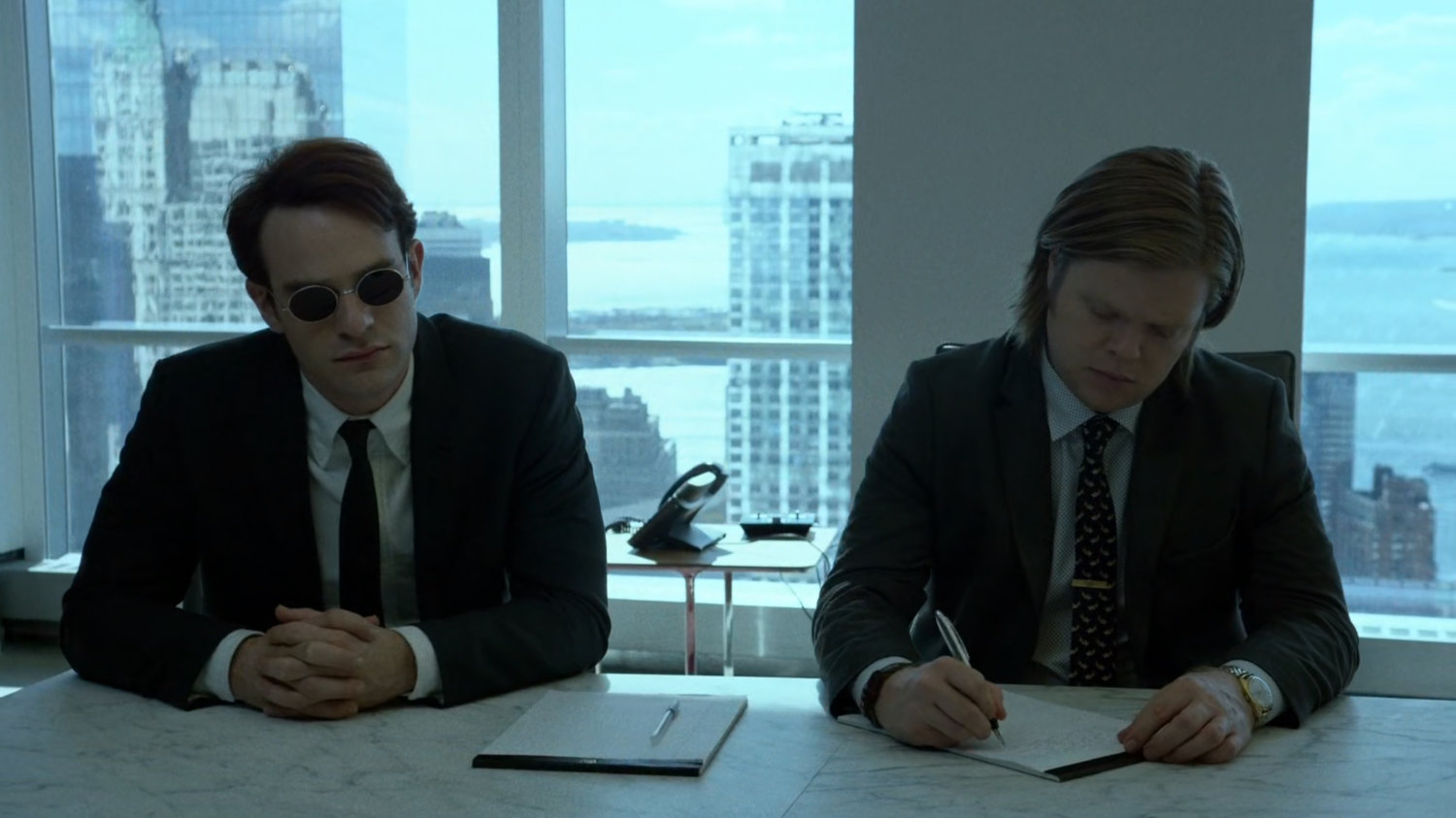 Matt and Foggy inside meeting room at Landman and Zack.