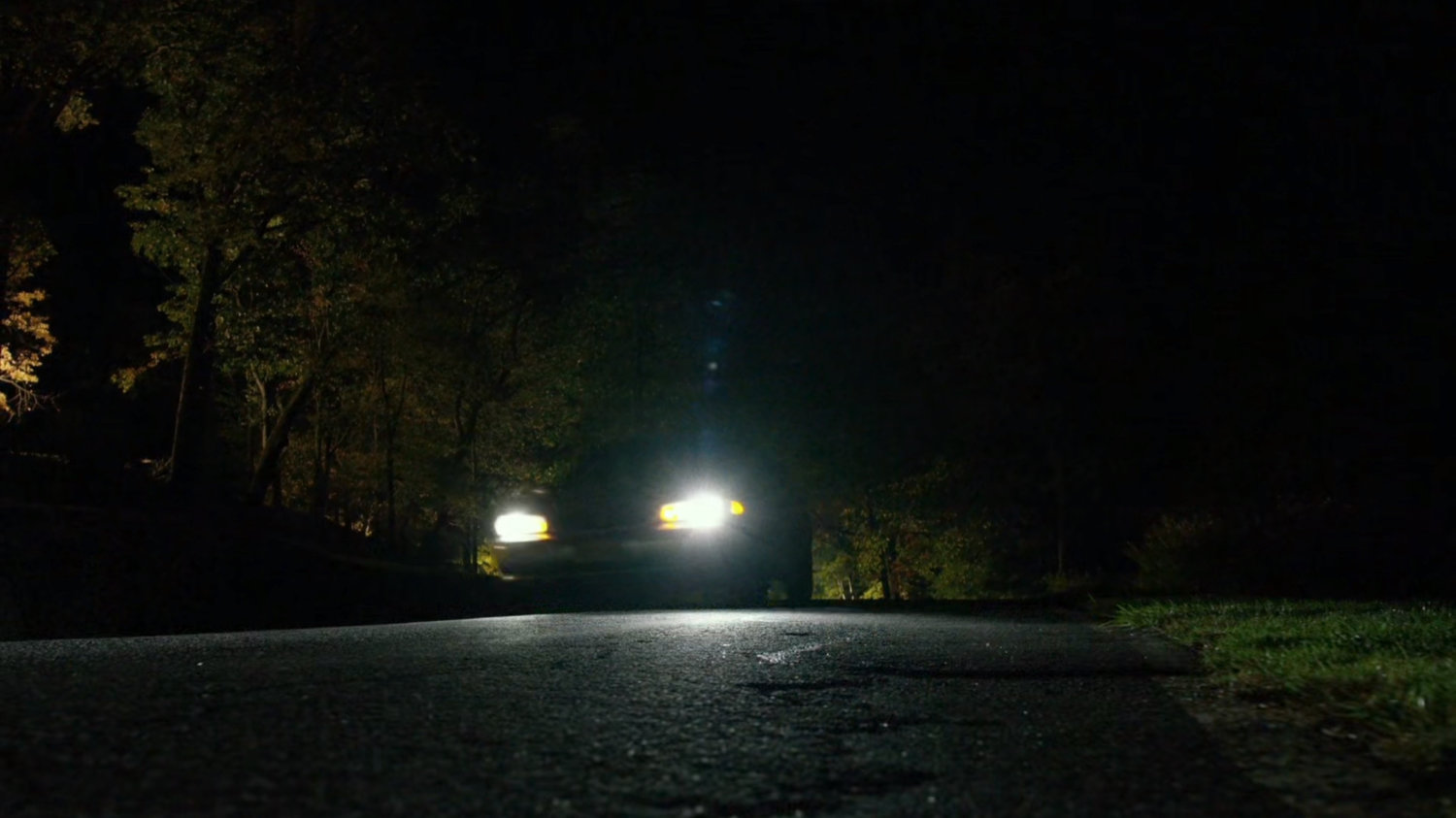Car on dark country road.